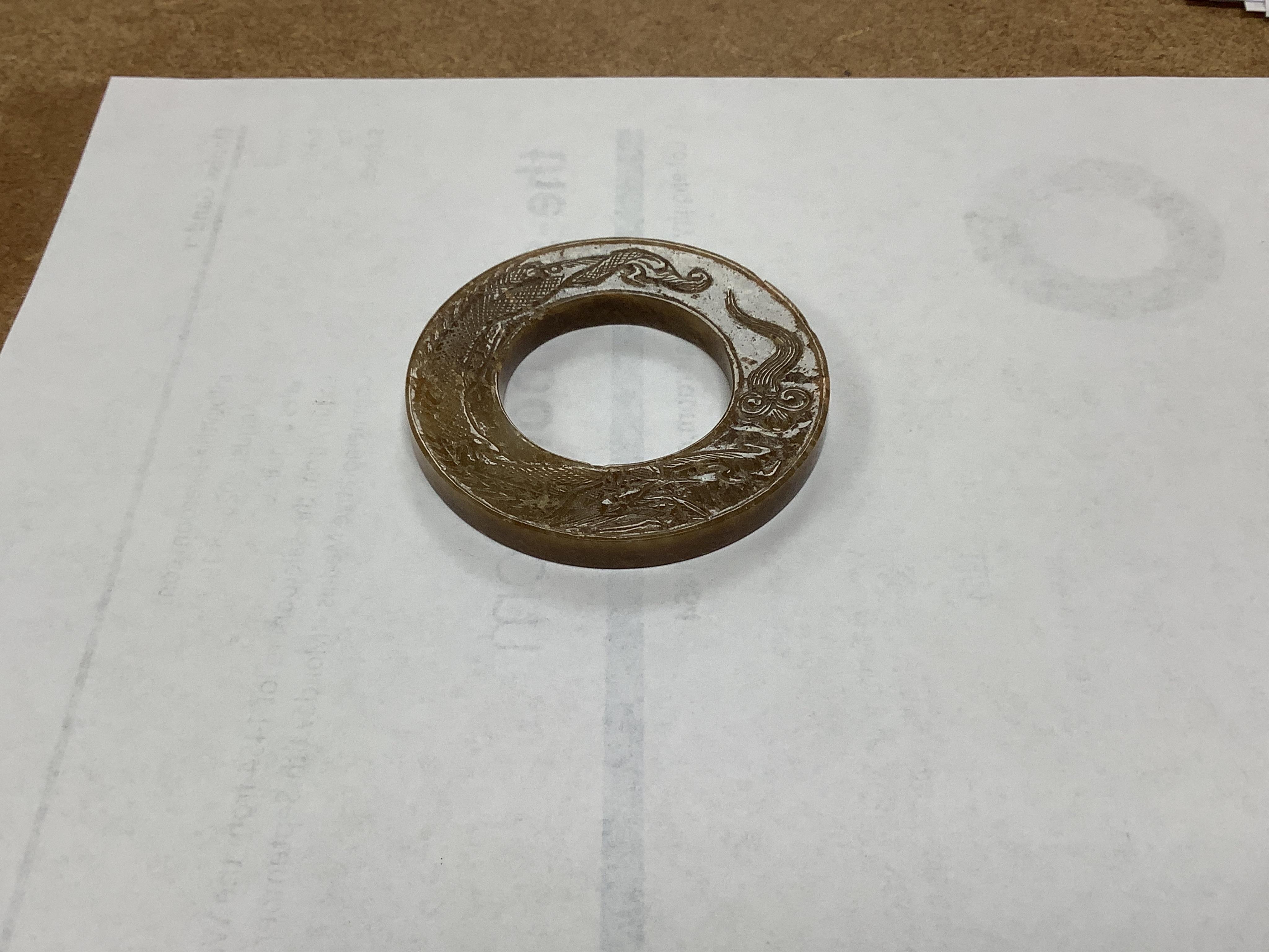 A Chinese russet jade dragon disc, 5.5cm diameter